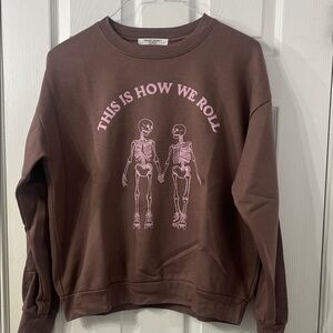 Project Social T Brown Crewneck Sweatshirt with Pink Skeleton Graphic